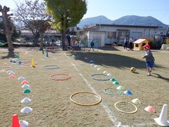 園庭で遊んでいる幼児の写真