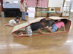 段ボールのキャタピラで子どもたちが遊んでいる様子