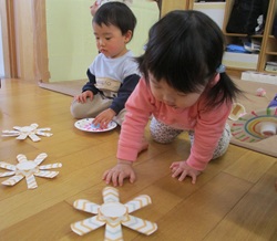 1歳児がこま回しをしている写真